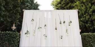wedding altar white sheer sheet backdrop with hanging flowers