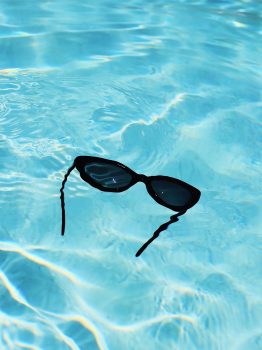 sunglasses floating in pool